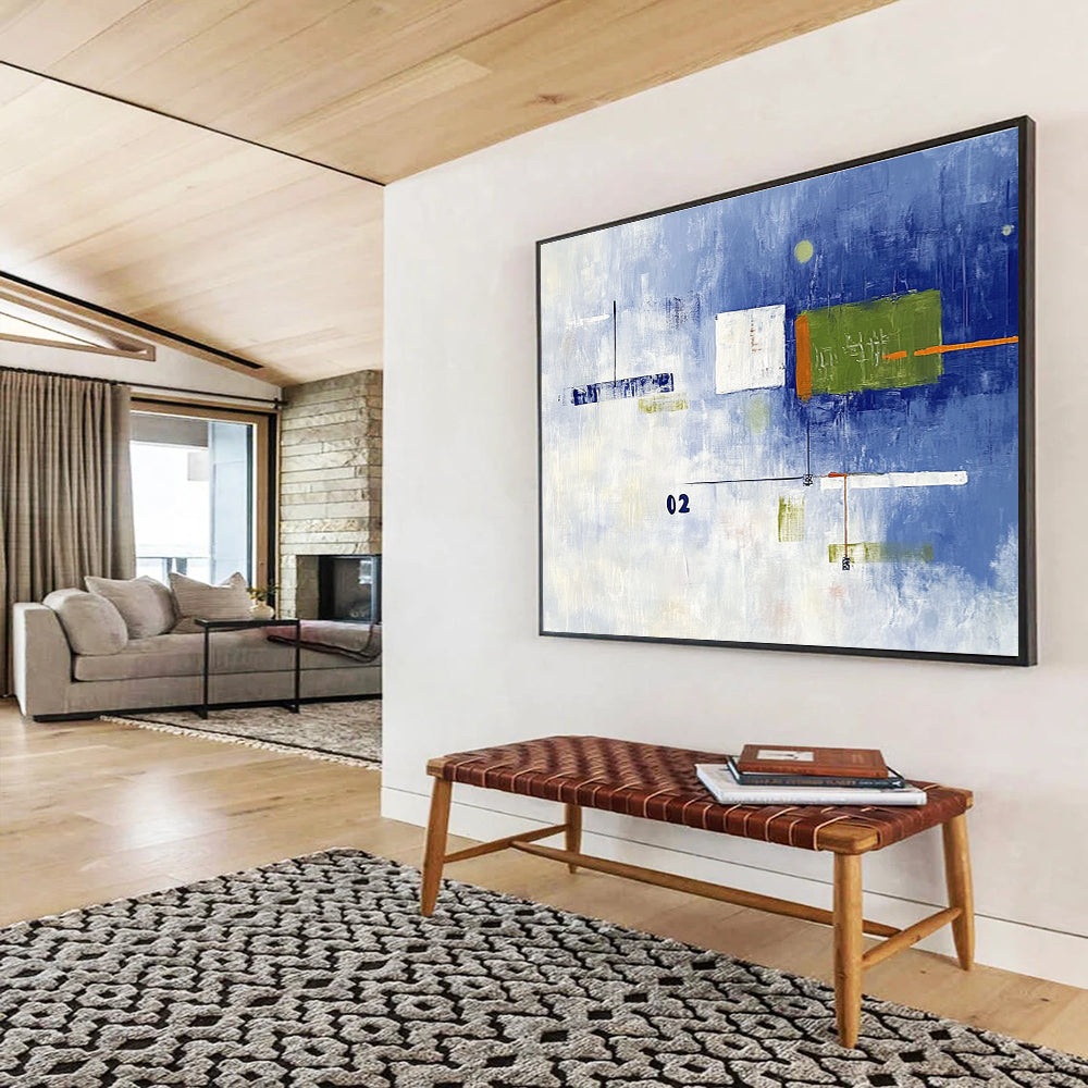 A large abstract painting with broad brush strokes in cool blue and white, featuring bold geometric shapes in green and orange, creating depth and contrast.SC493