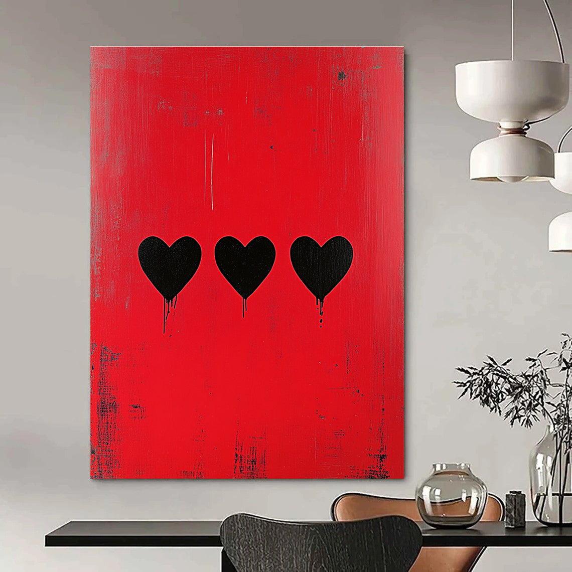 Large abstract painting with a striking red background featuring three bold black hearts in a style reminiscent of Banksy.STSC1164