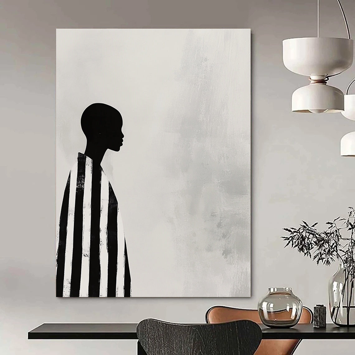 A large abstract painting featuring a striking black and white profile of an African woman in striped robes against a soft gray background.STSC1079
