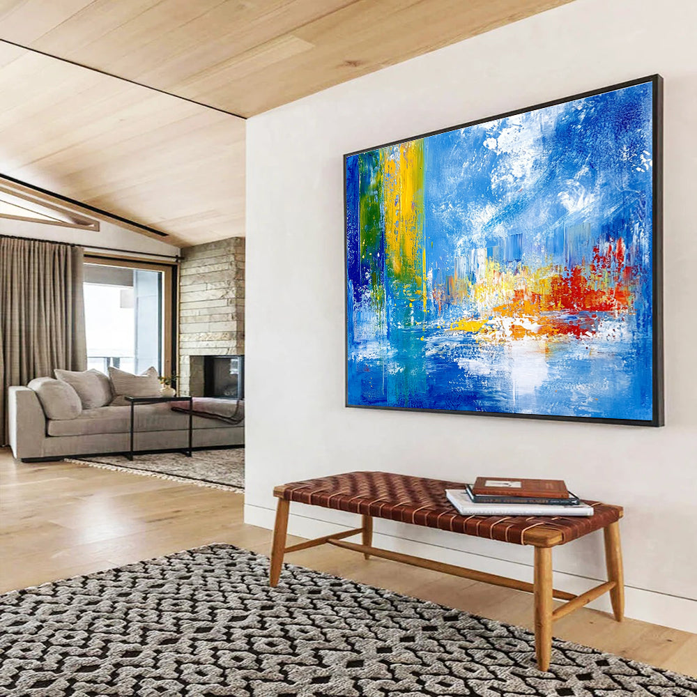 Bold abstract painting with vibrant teal yellow and red colors depicting an underwater city under sea ice against a blue sky and cloud backdrop.SC028