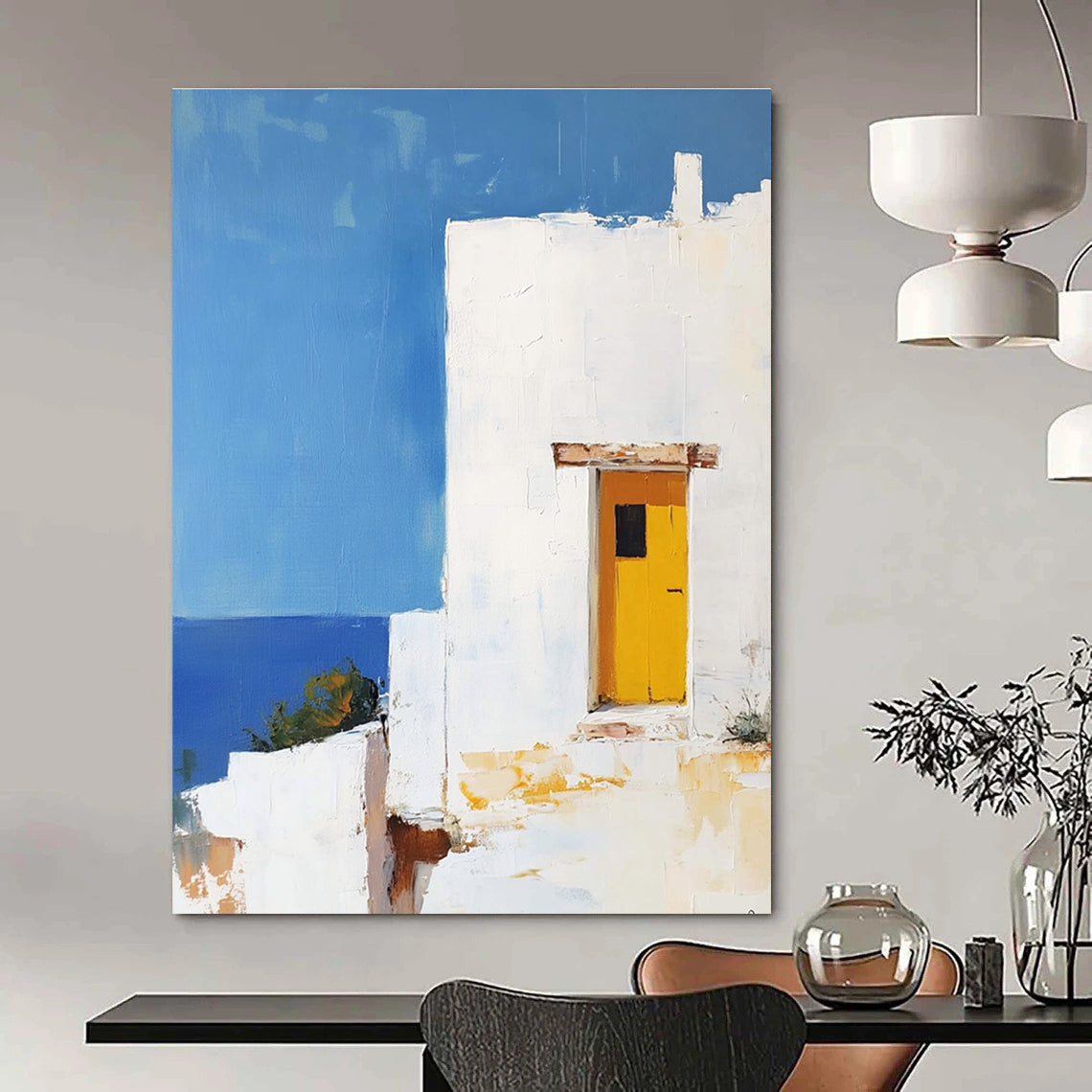 Large abstract painting featuring a white Greek house with a yellow door set against a blue sky in minimalistic style.STSC1252