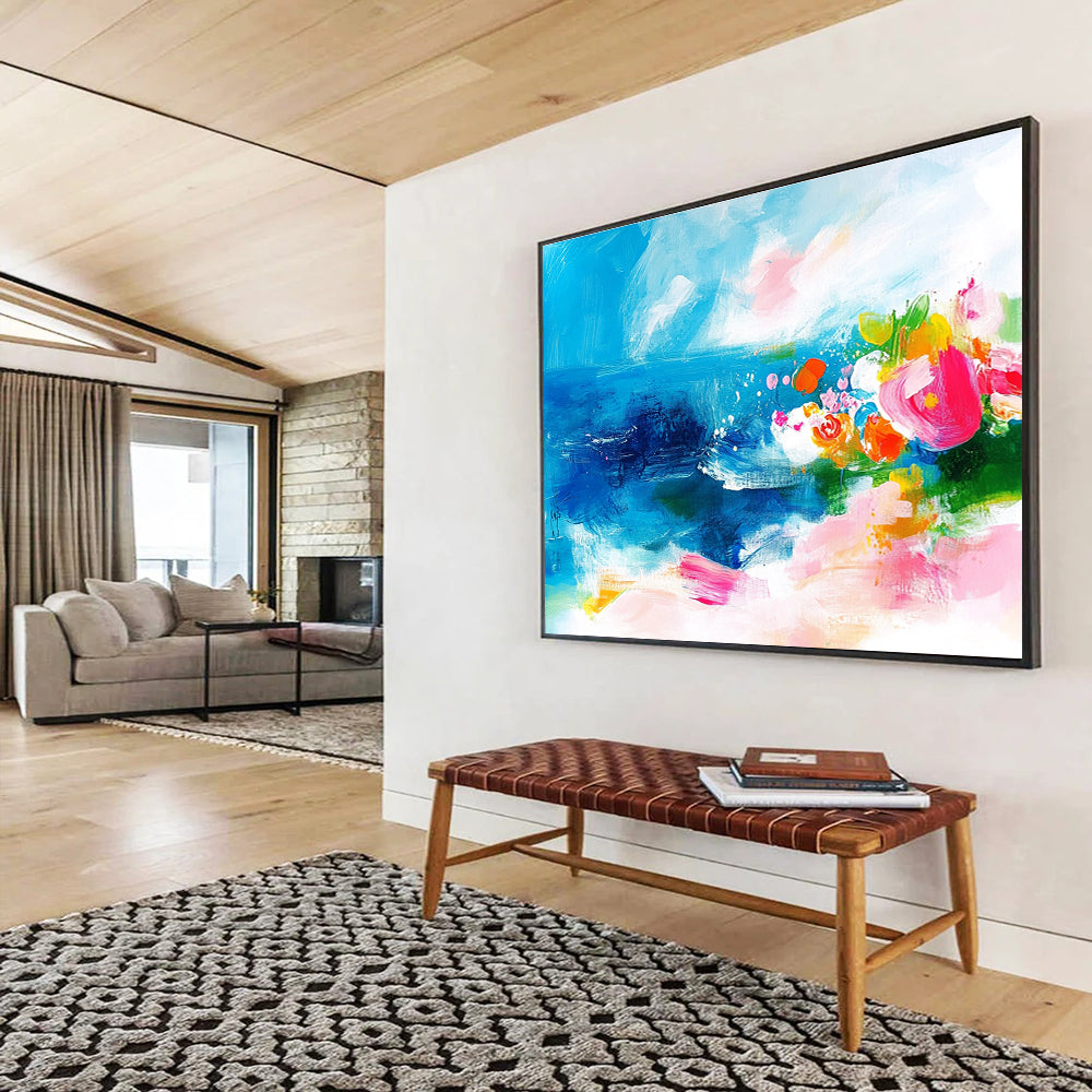 Large abstract painting of the ocean featuring bold brush strokes in pink blue green and orange with small flowers on a textured white background.SC363