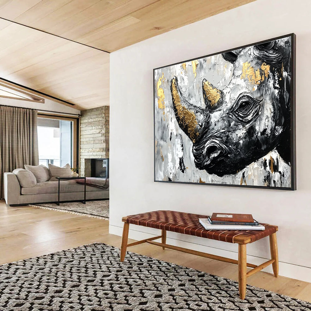 Abstract painting of an African rhinoceros in black and white with gold accents and textured strokes on a neutral background.SC151