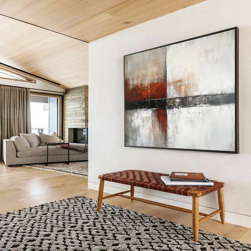 Large abstract painting with a calming color palette of white gray and soft tones featuring dark red orange brushstrokes and textured layers.SC592