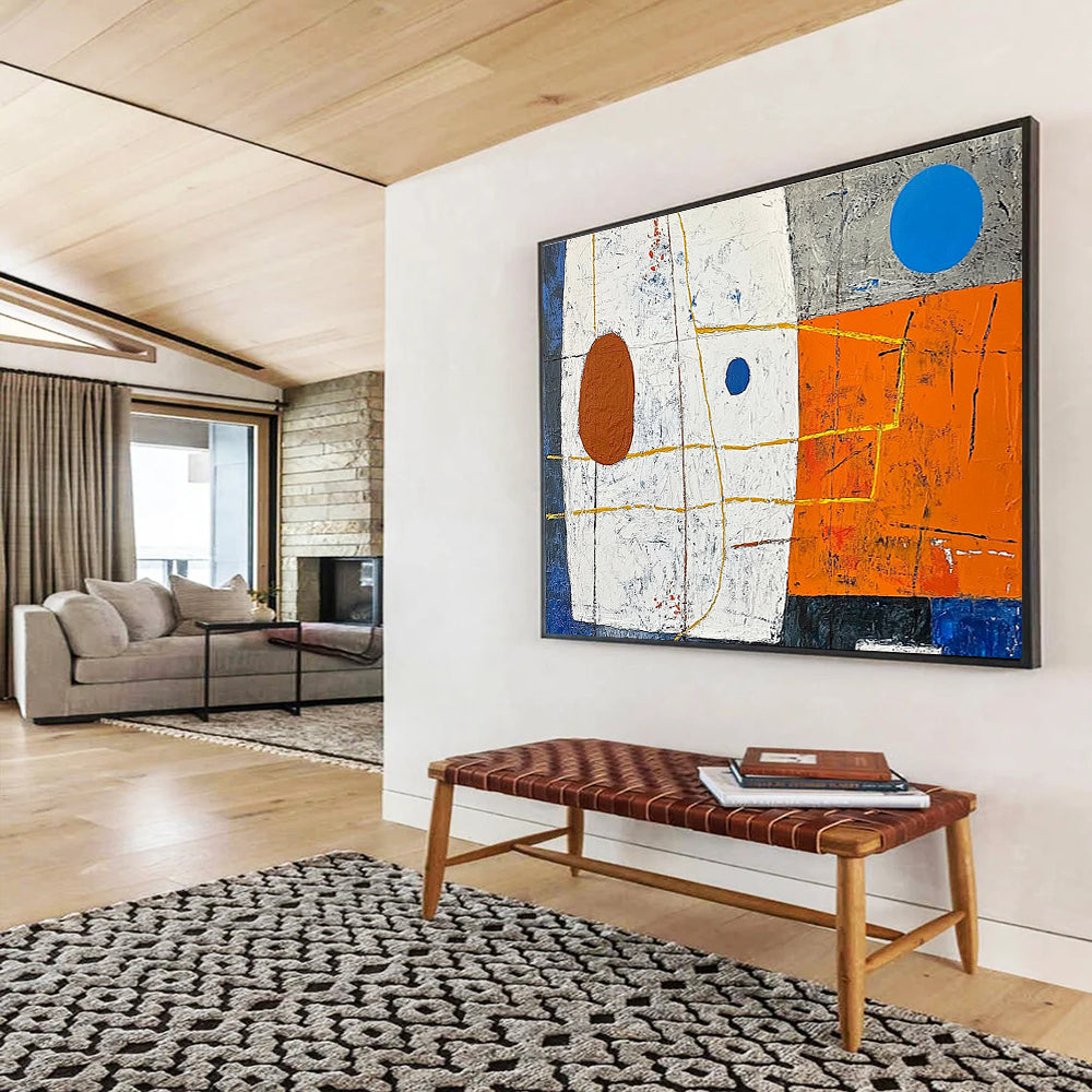 A large abstract painting featuring white squares orange and blue shapes yellow lines a small brown oval and a blue dot on a vibrant orange and dark grey background.SC376