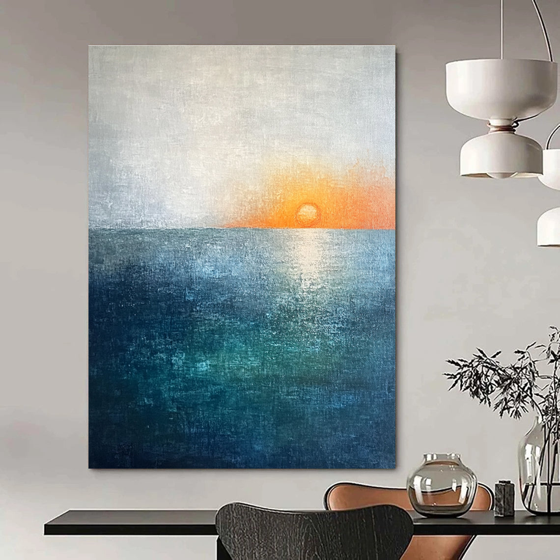 Large abstract painting featuring a soft sky blue and teal gradient with a grey expanse and a small orange sun setting on the horizon.STSC094