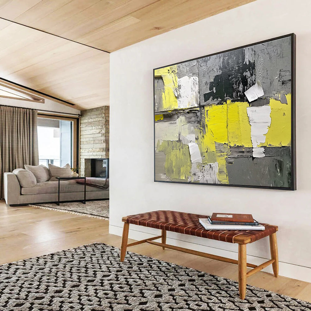 Large abstract painting featuring gray and yellow hues with textured paper elements extending from the wall for added dimension.SC240