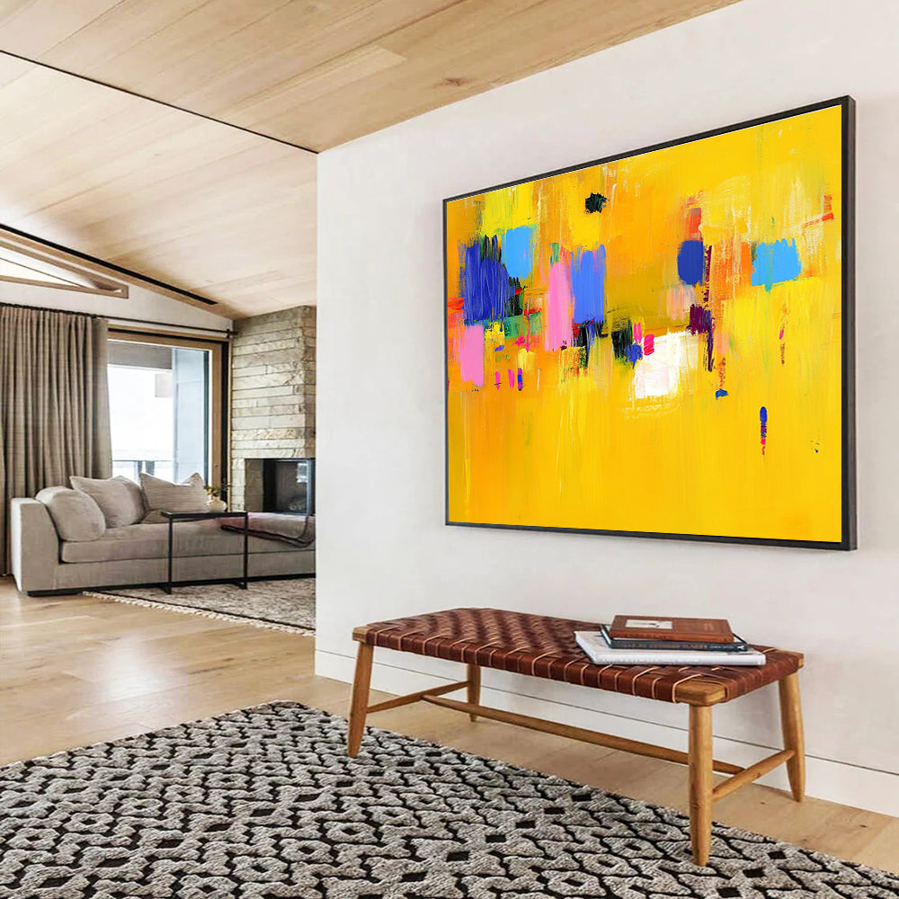 Large abstract painting featuring bold yellow and blue strokes with pink accents dynamic lines and vibrant textures creating an energetic atmosphere.SC147