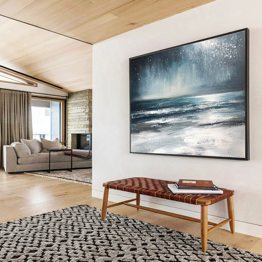 Large abstract painting depicting a winter ocean scene with dark blue and gray tones a starry white sky and sandy beach resembling snow.SC412