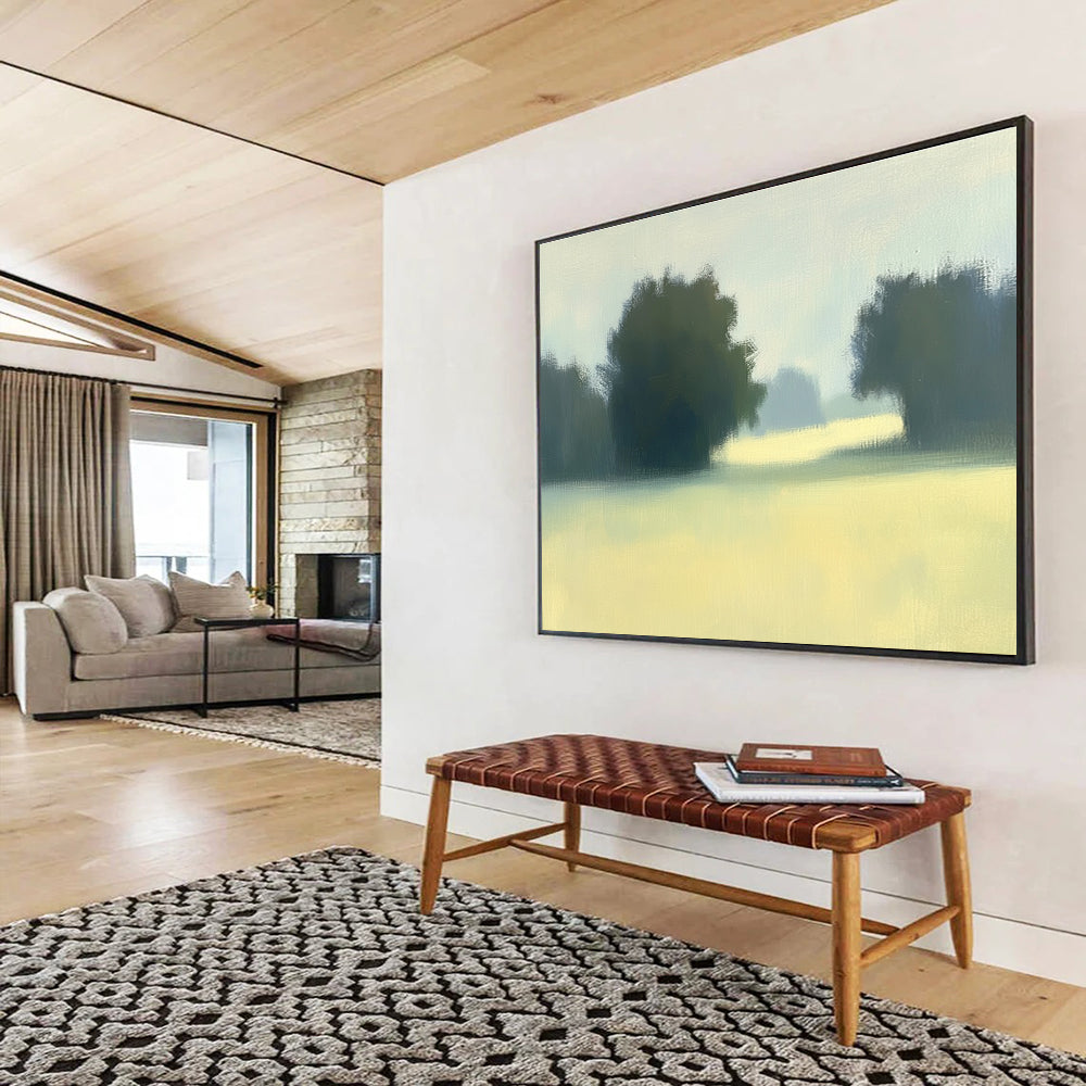 A large abstract painting featuring impasto technique with soft hues of green and yellow depicting a hazy field with distant trees.SC498