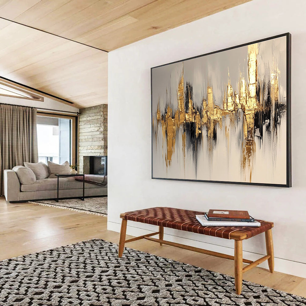 Large abstract painting of a cityscape in gold and white, featuring bold brush strokes on a white background with neutral tones.SC170