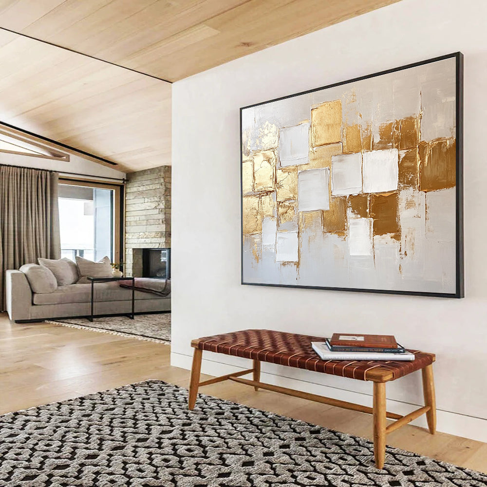 Large abstract painting in white and gold featuring textured square block patterns and soft lighting for an elegant touch.SC292