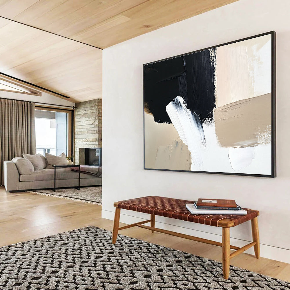 Large abstract painting featuring black brush strokes on a white background complemented by a minimalist beige and cream color palette.SC012