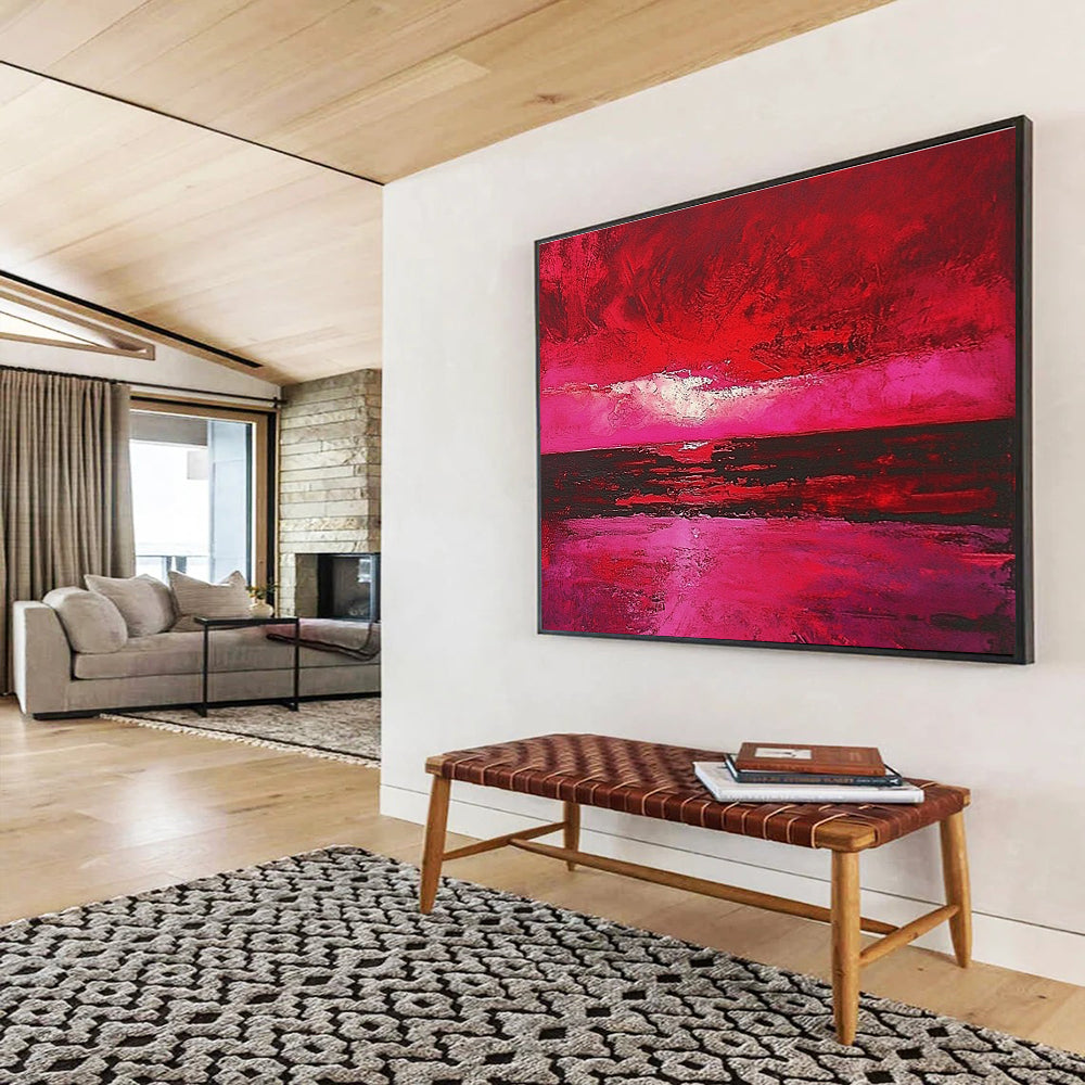 Large abstract painting depicting a red sky over the sea with hues of pink and crimson capturing the beauty of a sunset.SC273