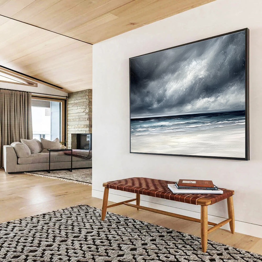 Large abstract painting featuring an ocean with stormy gray clouds and a white sand beach in soft gray and blue tones.SC163
