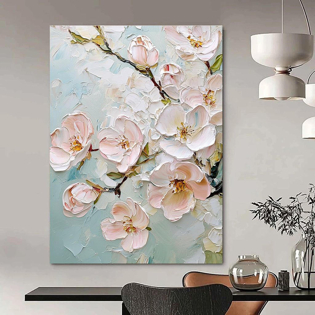 Large abstract painting featuring delicate cherry blossoms in soft pink and white against a light blue background with rich impasto texture.STSC875