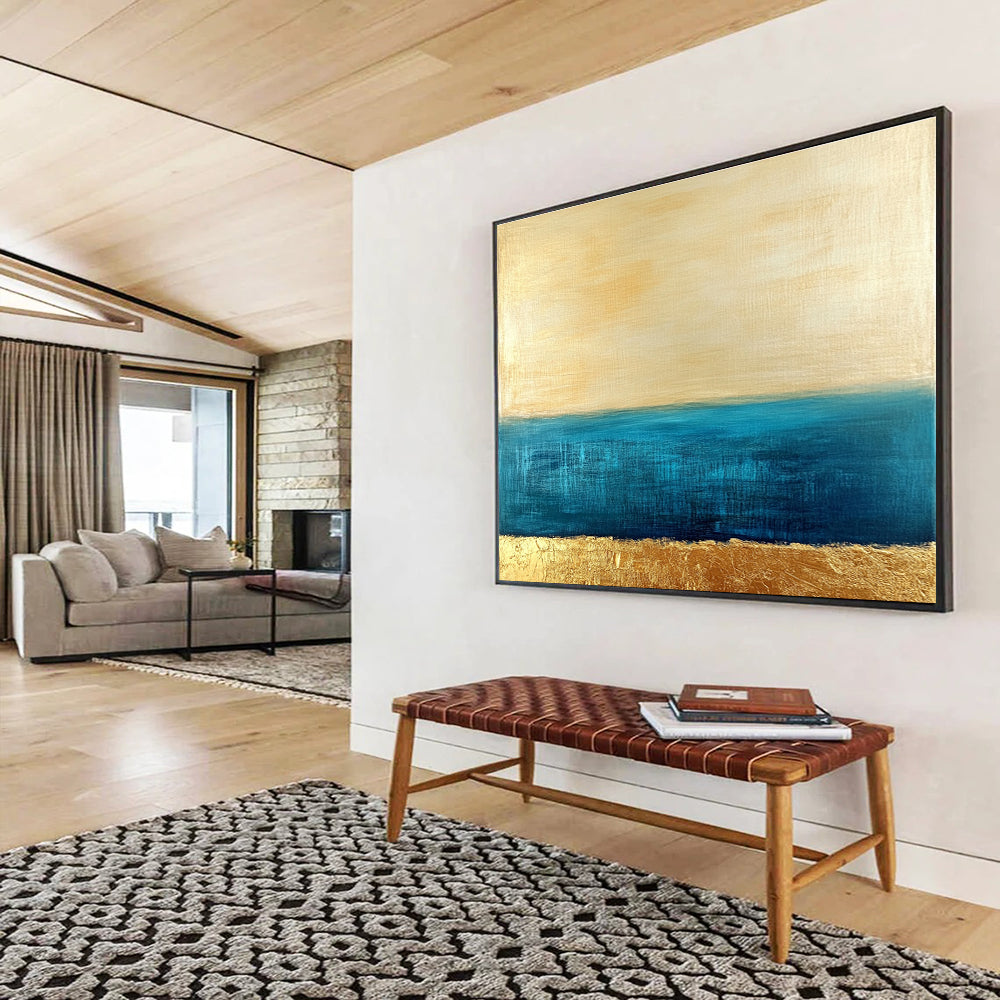 Large abstract painting featuring a golden sky and blue sea with textured gold accents and a soft minimalist aesthetic.SC172