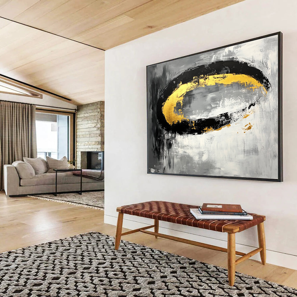 Large abstract painting featuring black white gray tones with gold accents and oval brush strokes on canvas.SC137