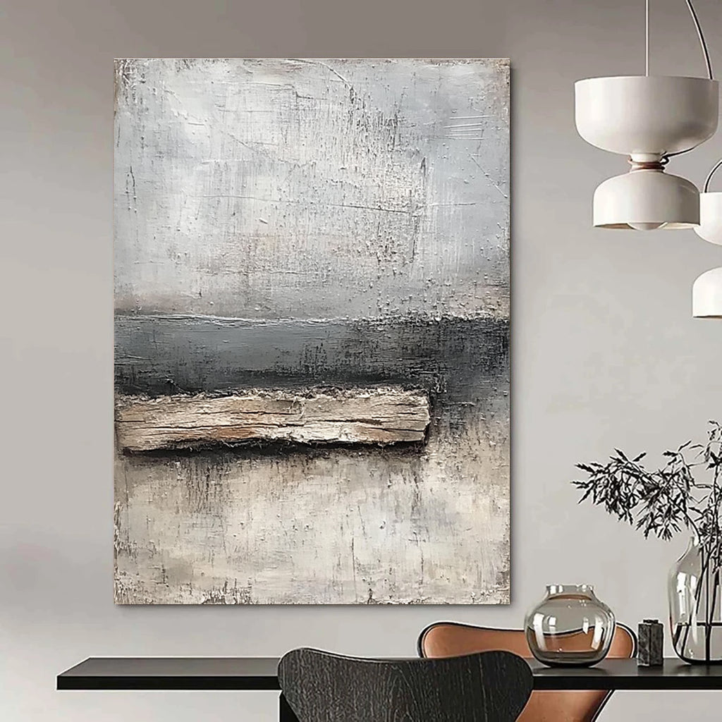 Abstract painting featuring neutral tones of gray and white with textured canvas and thick paint highlighting a small piece of old wood by the water's edge.STSC138