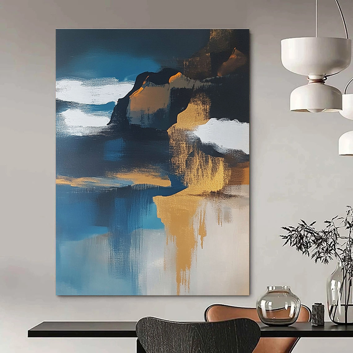 Large abstract painting of an island featuring navy blue water white clouds brown sand and gold leafing exuding a sense of calmness.STSC651