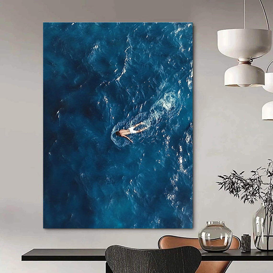Large abstract painting depicting a solitary man in deep blue ocean waves wearing white swim trunks evoking solitude and calmness amidst chaos.STSC1057