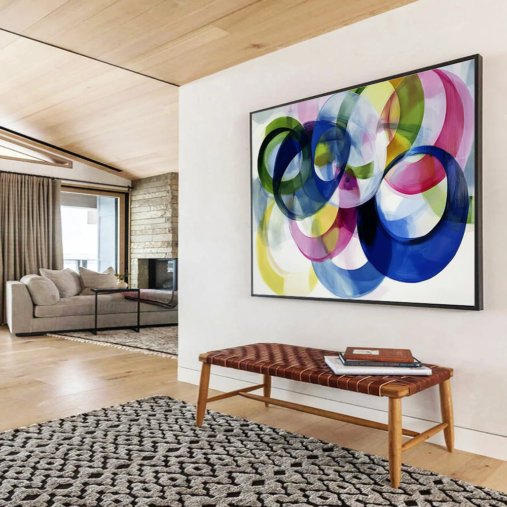Large abstract painting with colorful overlapping circles on a white background showcasing joyful energy and playful modernity through soft edges and visible brushstrokes.SC525