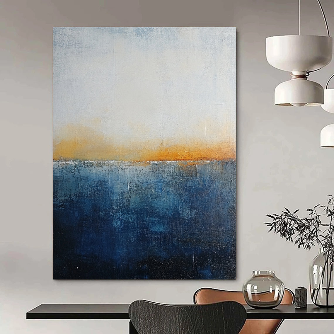 Large abstract painting with layered blue and yellow textures evokes oceanic depths at dusk with soft lighting enhancing movement and depth.STSC109