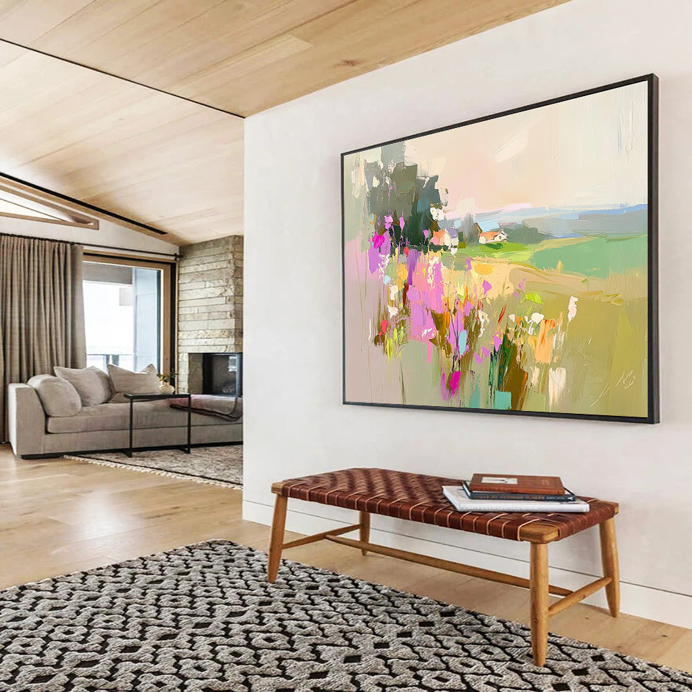 Large abstract painting featuring a floral landscape with fields and a distant cottage in soothing pink purple green and blue tones.SC110