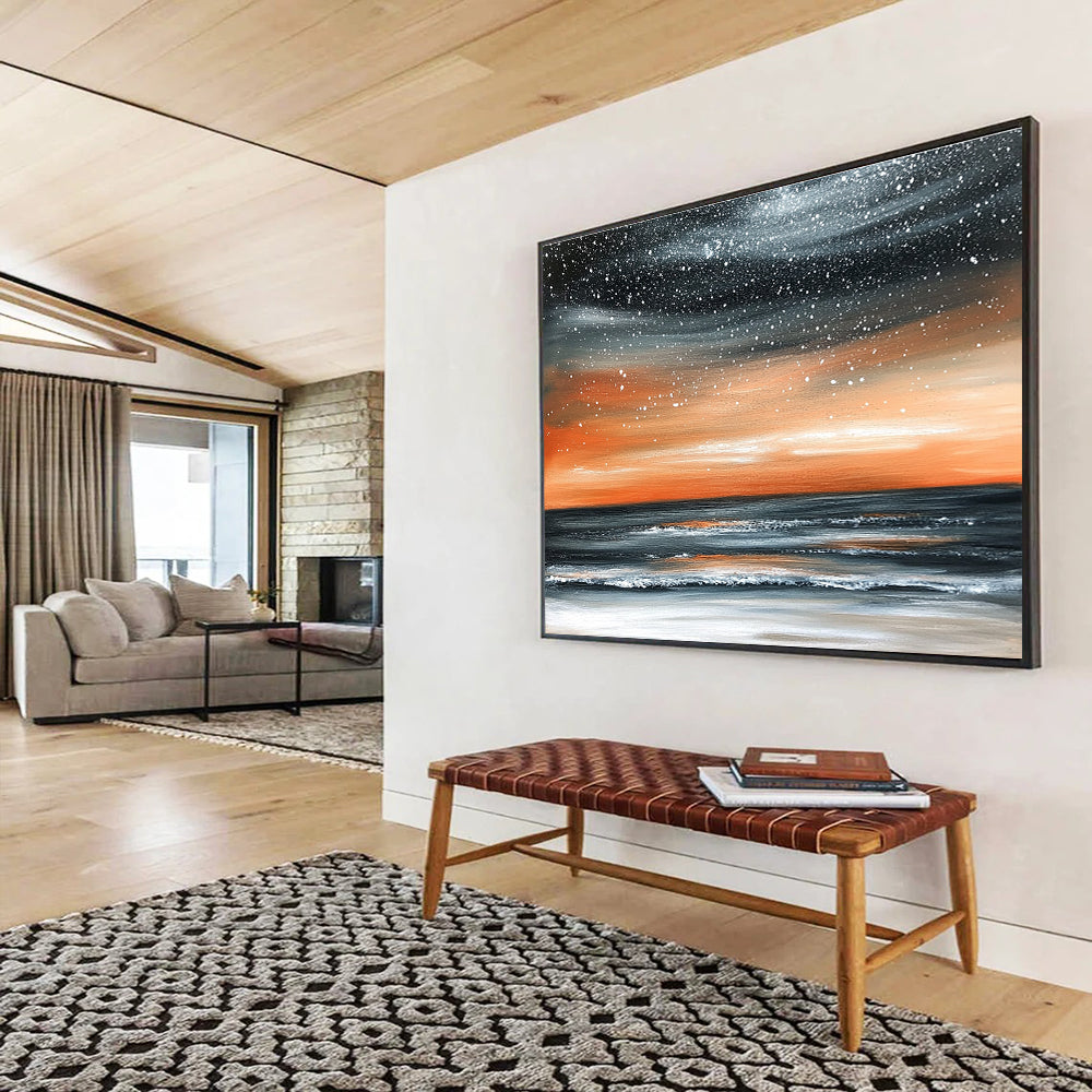 Large abstract painting of the ocean at night featuring an orange gray sky and starry snowfall over a muted water surface.SC130
