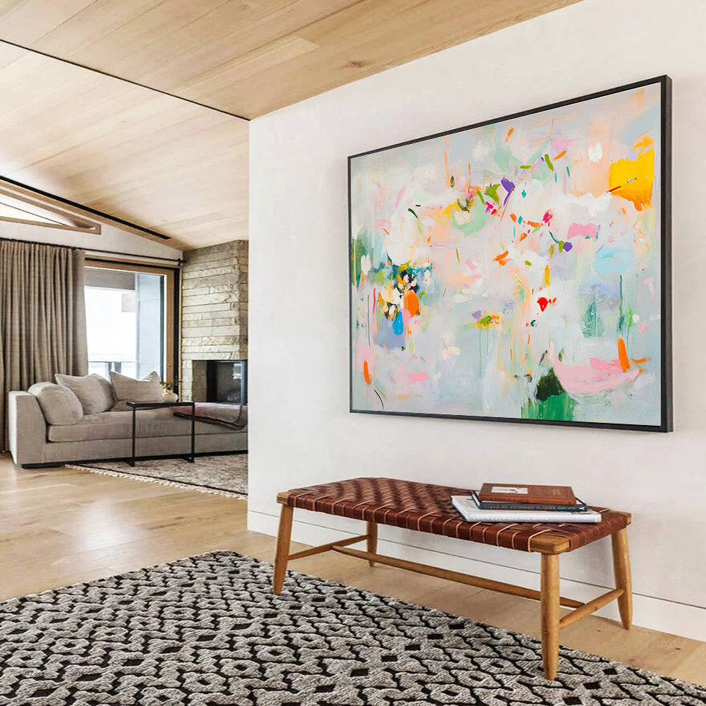 Large abstract painting in soft pastels featuring spring themes with flowers leaves trees and vibrant splashes of color creating a lively atmosphere.SC384