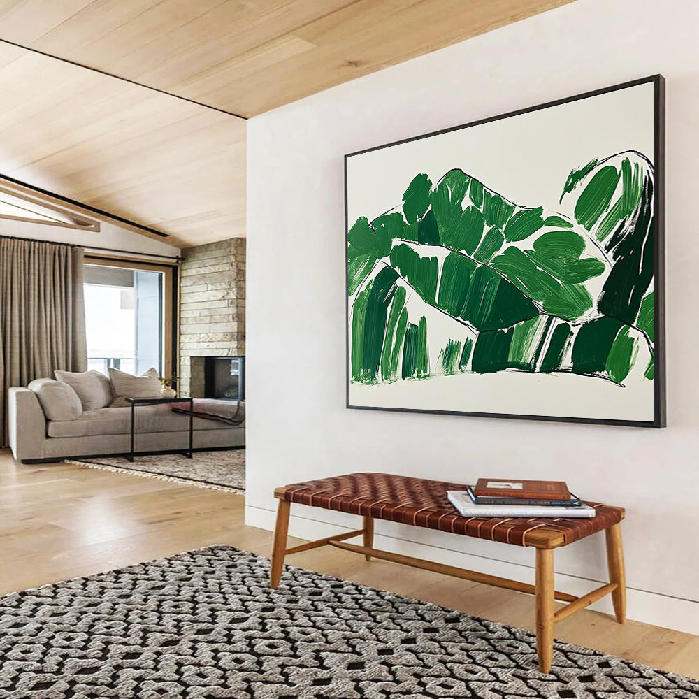 A large abstract painting featuring green leaves in the shape of a woman lounging on a couch with minimalist brush strokes on a white background.SC551