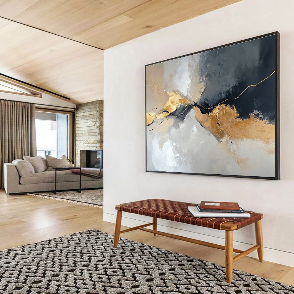 Large abstract painting with an aerial view in gray and beige colors featuring minimalistic shapes and brush strokes enhanced with gold accents.SC104
