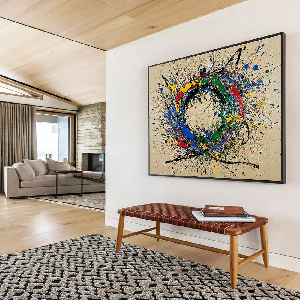 A large abstract painting featuring a circular splash pattern in blue red green yellow and black on a beige background.SC331