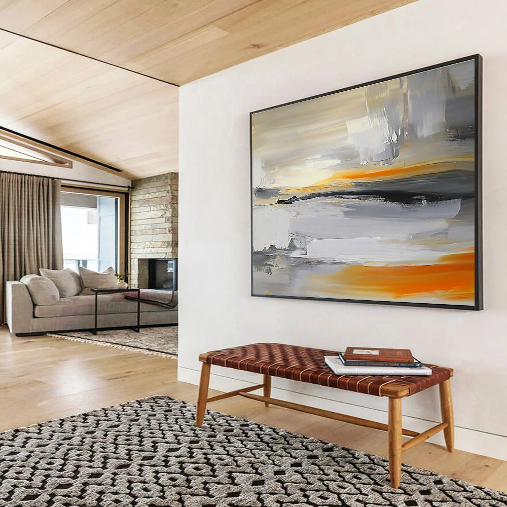 Large abstract painting featuring a grey, white, and orange sky with a blurred horizon and rocks below in a minimalist style.SC175