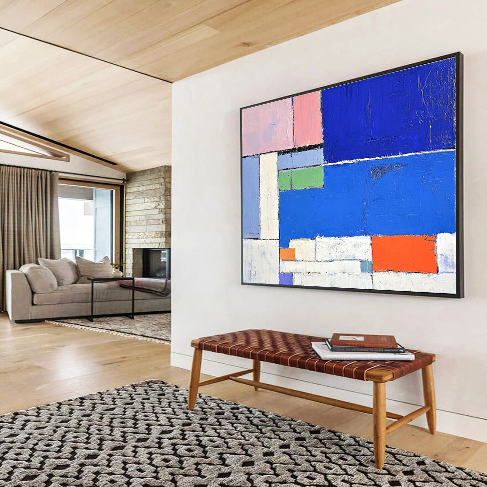 Large abstract painting featuring a vibrant blue sea white beach and colorful hotel with thick brush strokes and geometric shapes.SC169