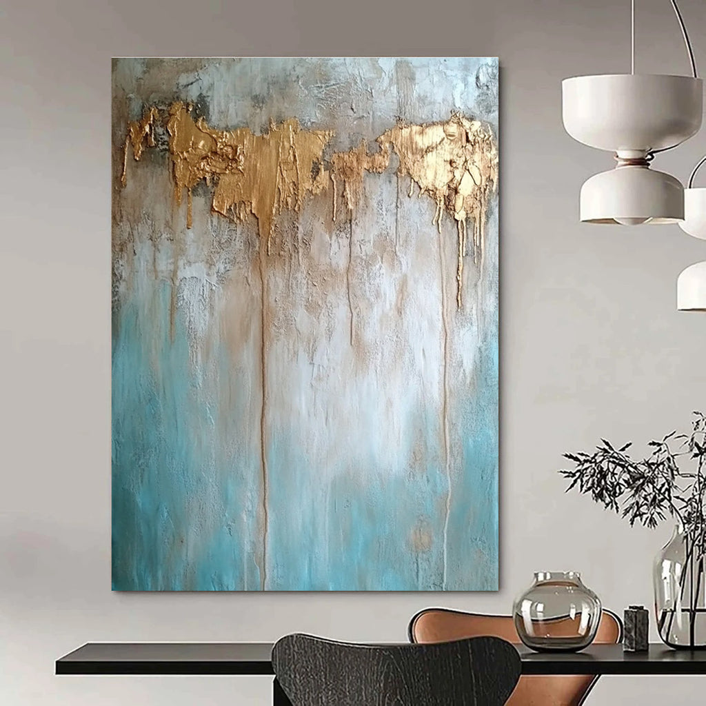 Large abstract painting with texture in neutral tones featuring light blue brown and gold hues highlighting water damage elements against a concrete wood background.STSC136