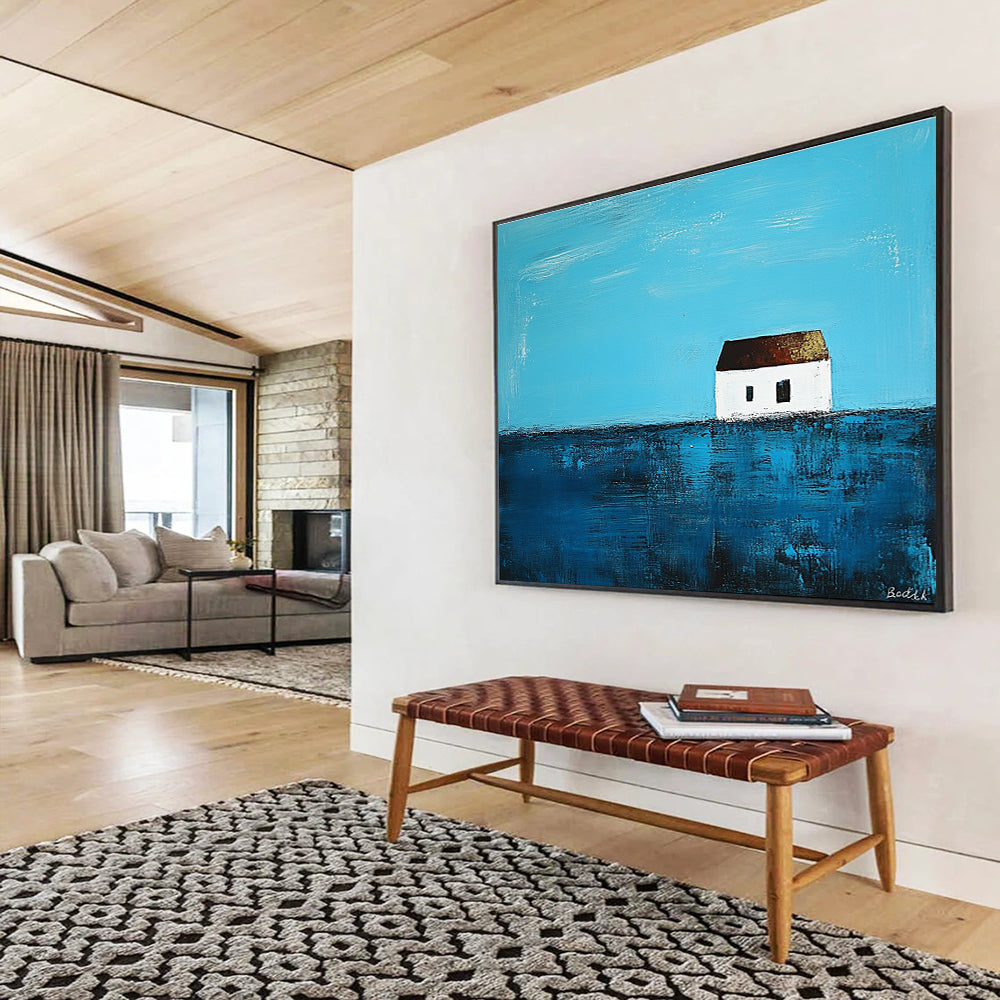 A large abstract painting featuring a small white house on the horizon surrounded by deep blue sea in the style of Anna Bocek.SC553
