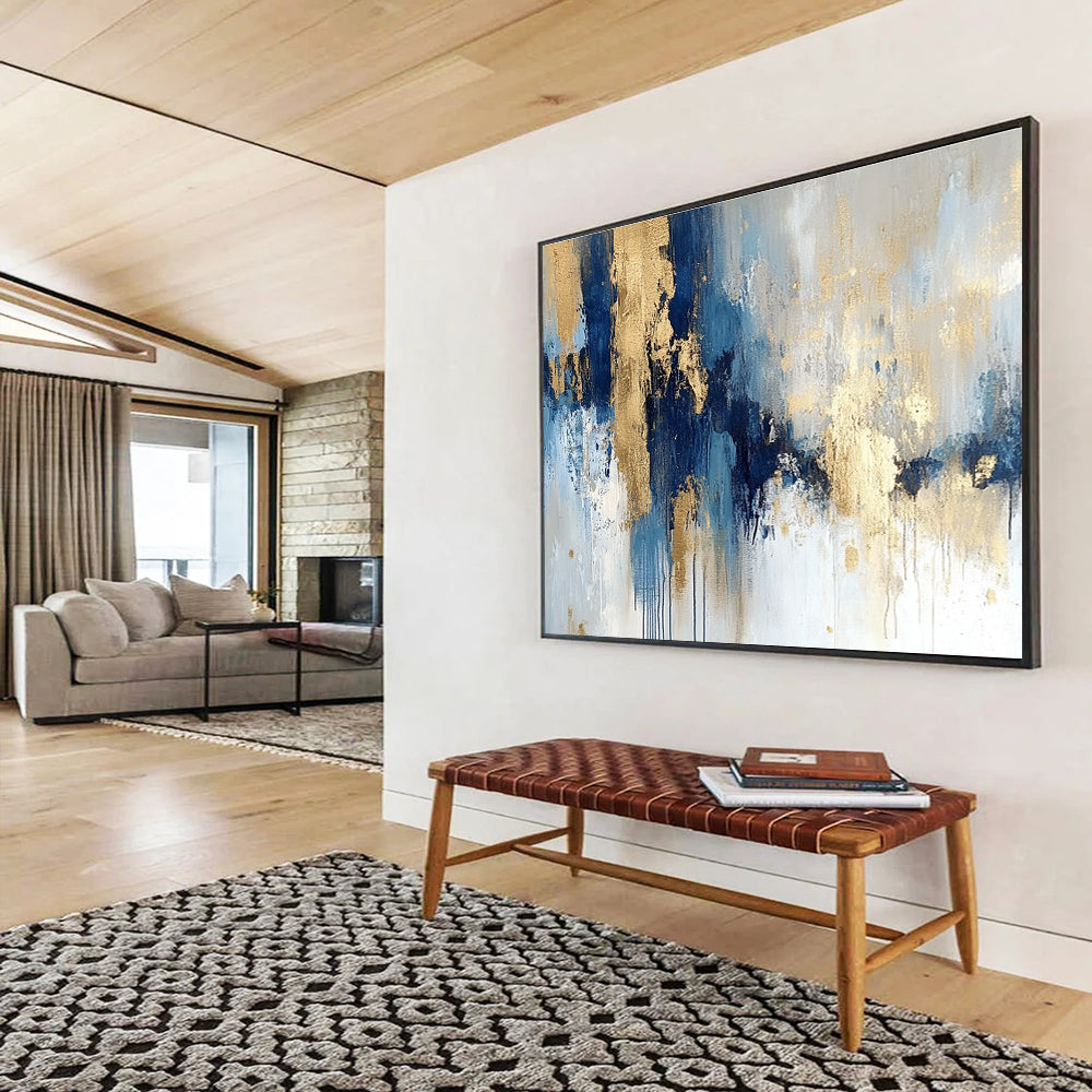 Large abstract painting in blue and gold with soft edges and texture featuring modern elegance and movement on a white background.SC021