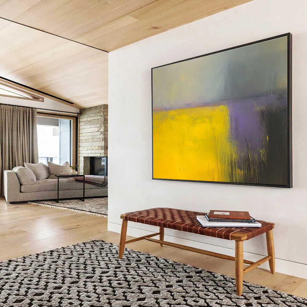A large abstract painting featuring vibrant yellow and gray fields with subtle purple hues, enhanced by dynamic brushstrokes and a blurred background.SC475
