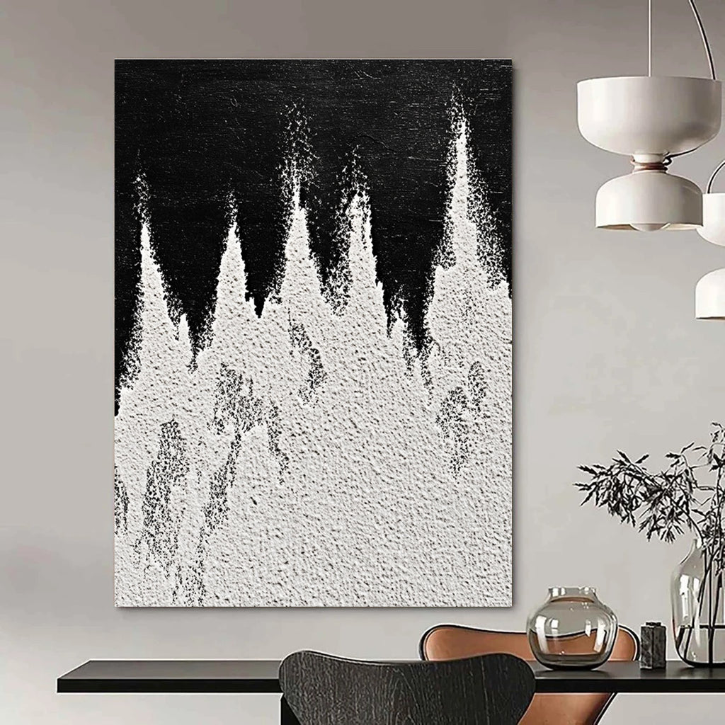 A large abstract painting featuring white powder on a black background with textured mountain ranges in playful gray and white tones capturing sharp edges.STSC1487