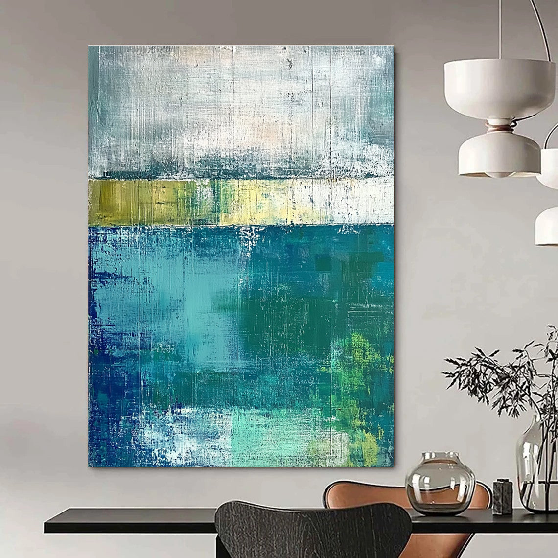 Large abstract painting with green and blue tones on a gray background evokes a serene water's edge mood with textured surfaces.STSC420