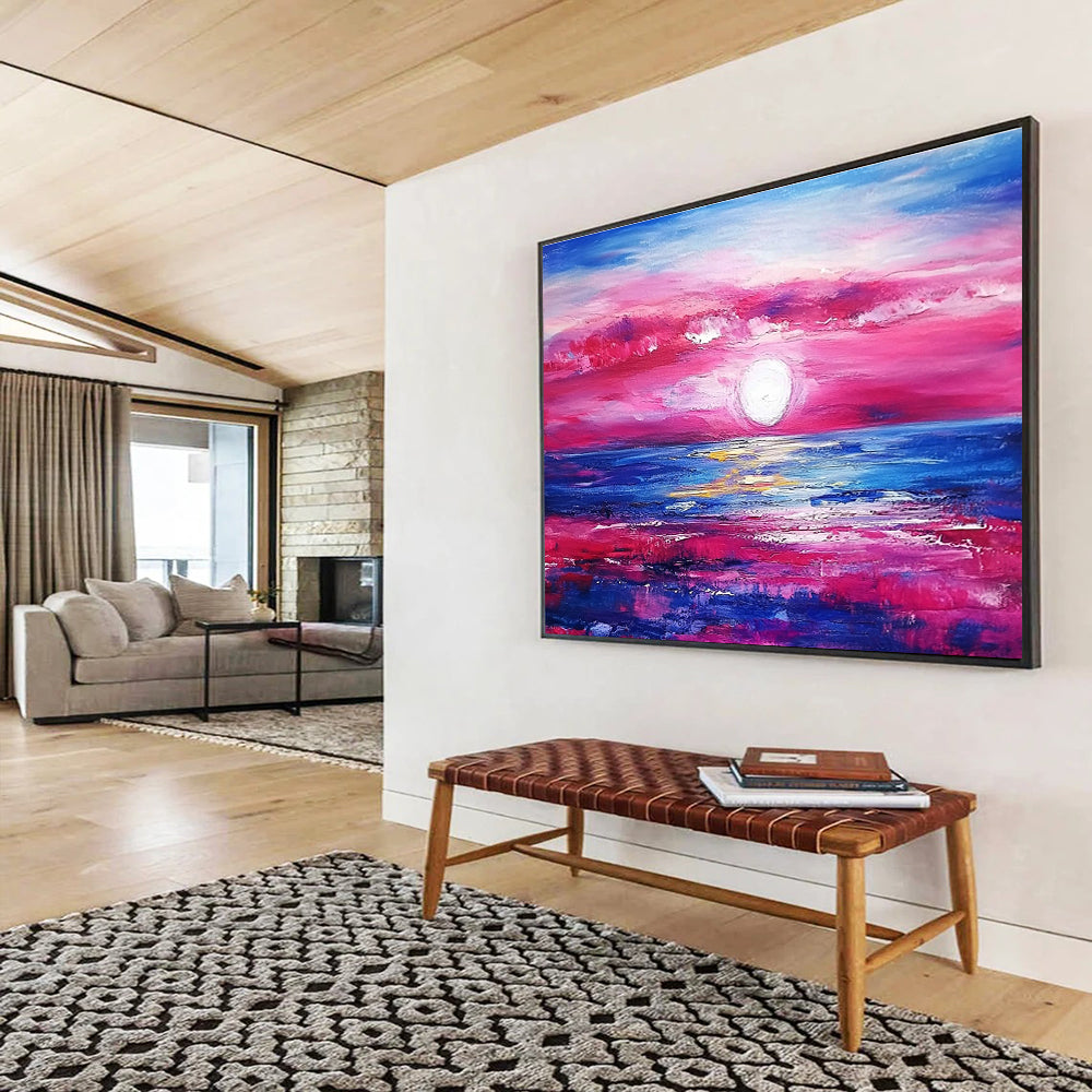A large abstract painting featuring a pink and blue sunset over the ocean with purple and red clouds by artist Anna Bocek.SC537