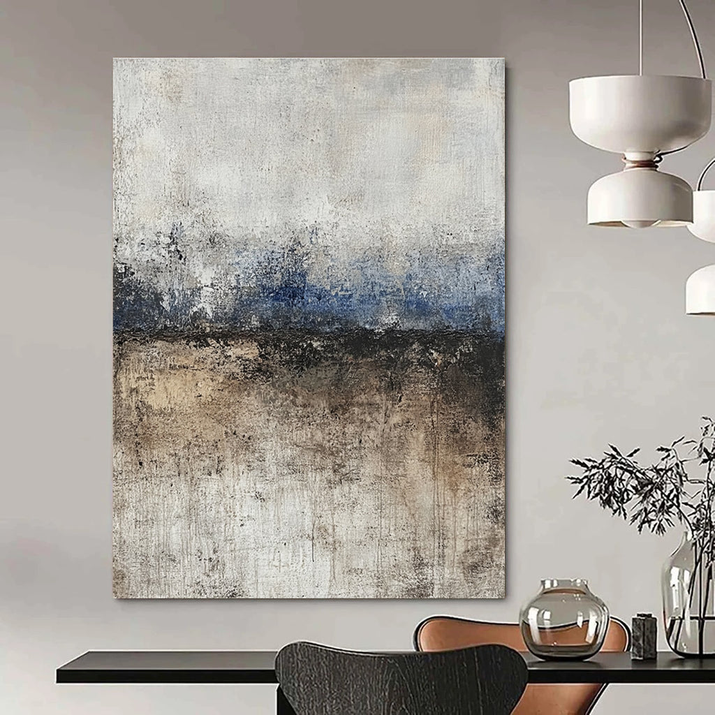 Large abstract painting featuring soft edges and subtle color transitions of beige blue-gray and brown with a path leading to tranquil water.STSC125