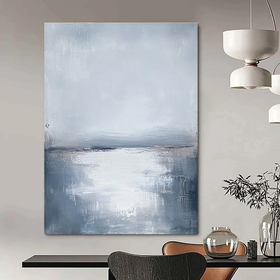 Large abstract painting featuring muted grays and soft blues capturing the serene connection between sunlit water and a cloudy sky.STSC464