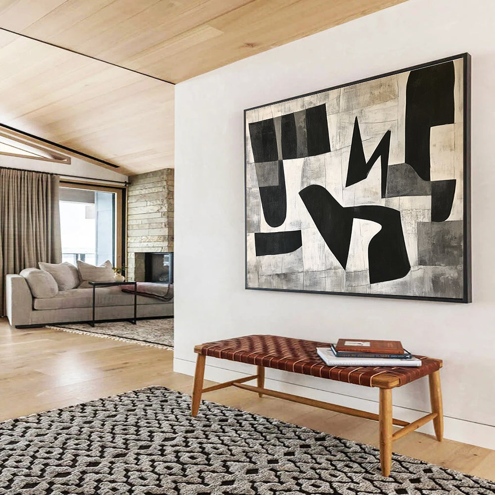 Large abstract painting featuring black and white geometric shapes in the letter K on a textured minimalist background conveying depth and movementSC517
