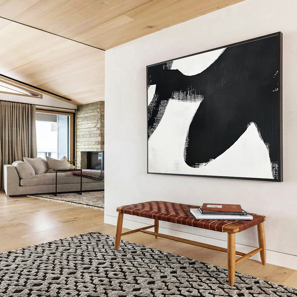 Large abstract painting in black and white featuring simple shapes and broad brush strokes inspired by an orca's tail flippers.SC016