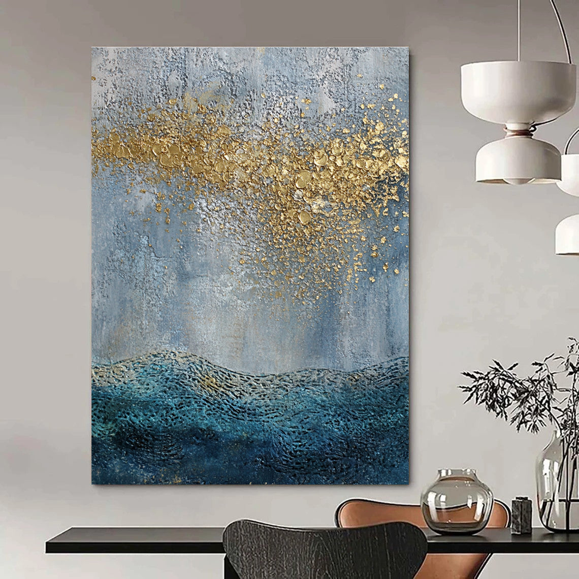 Large abstract painting with a textured sky-blue gray background and golden highlights featuring a textured sea with gentle waves in the foreground.STSC835