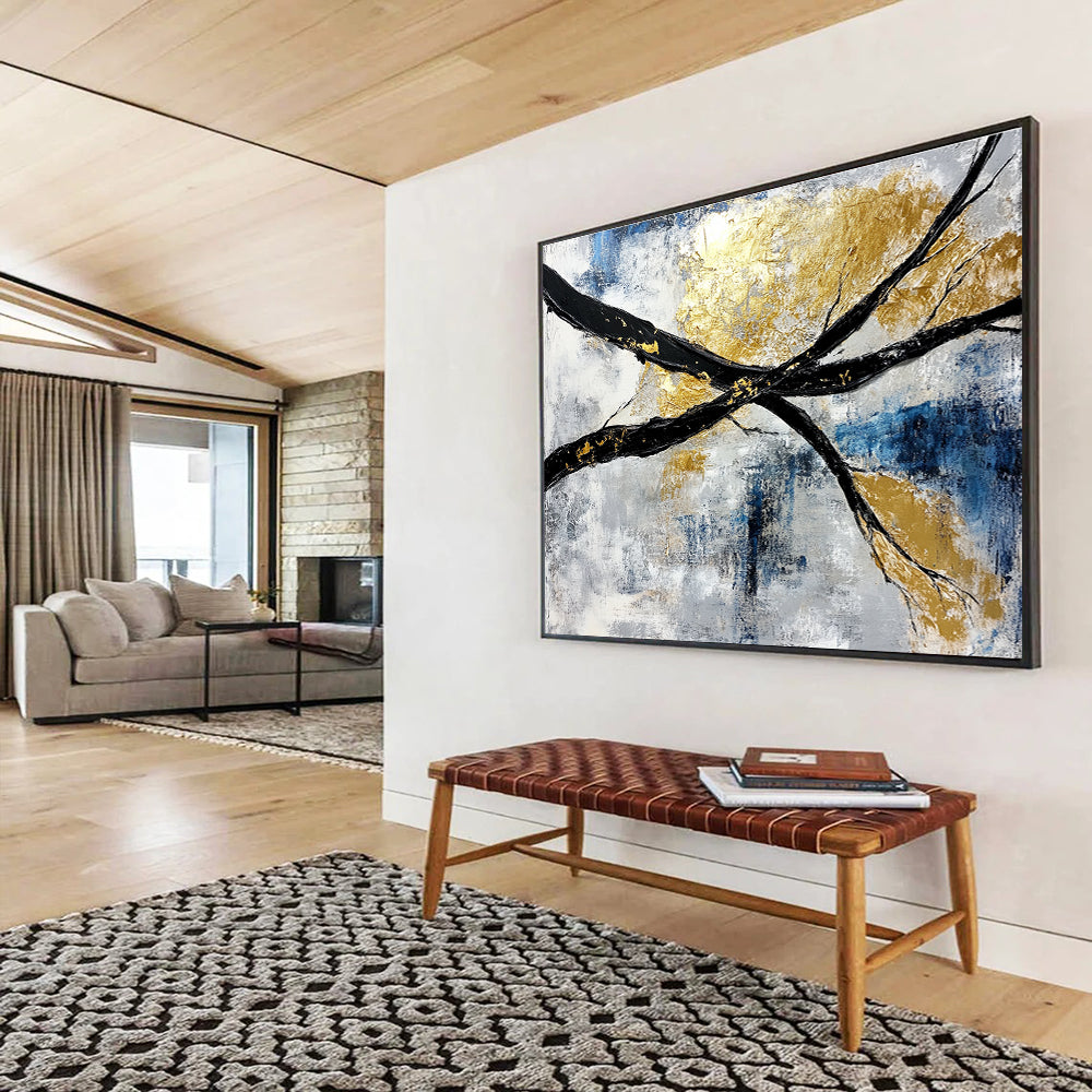 Abstract painting featuring black and white branches with gold leaf accents against a serene blue sky background.SC367
