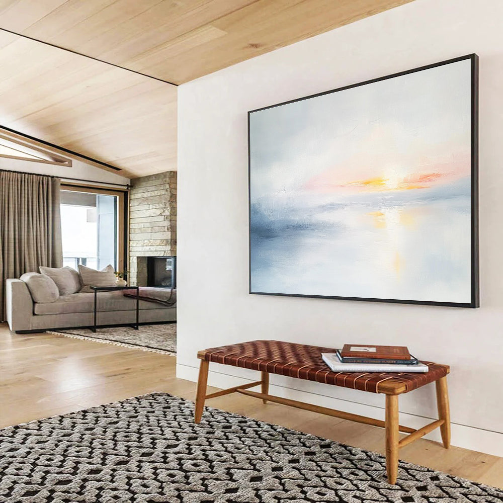 Large abstract painting featuring soft light sky blue and gray tones depicting a serene sunset over calm water on a white background.SC082