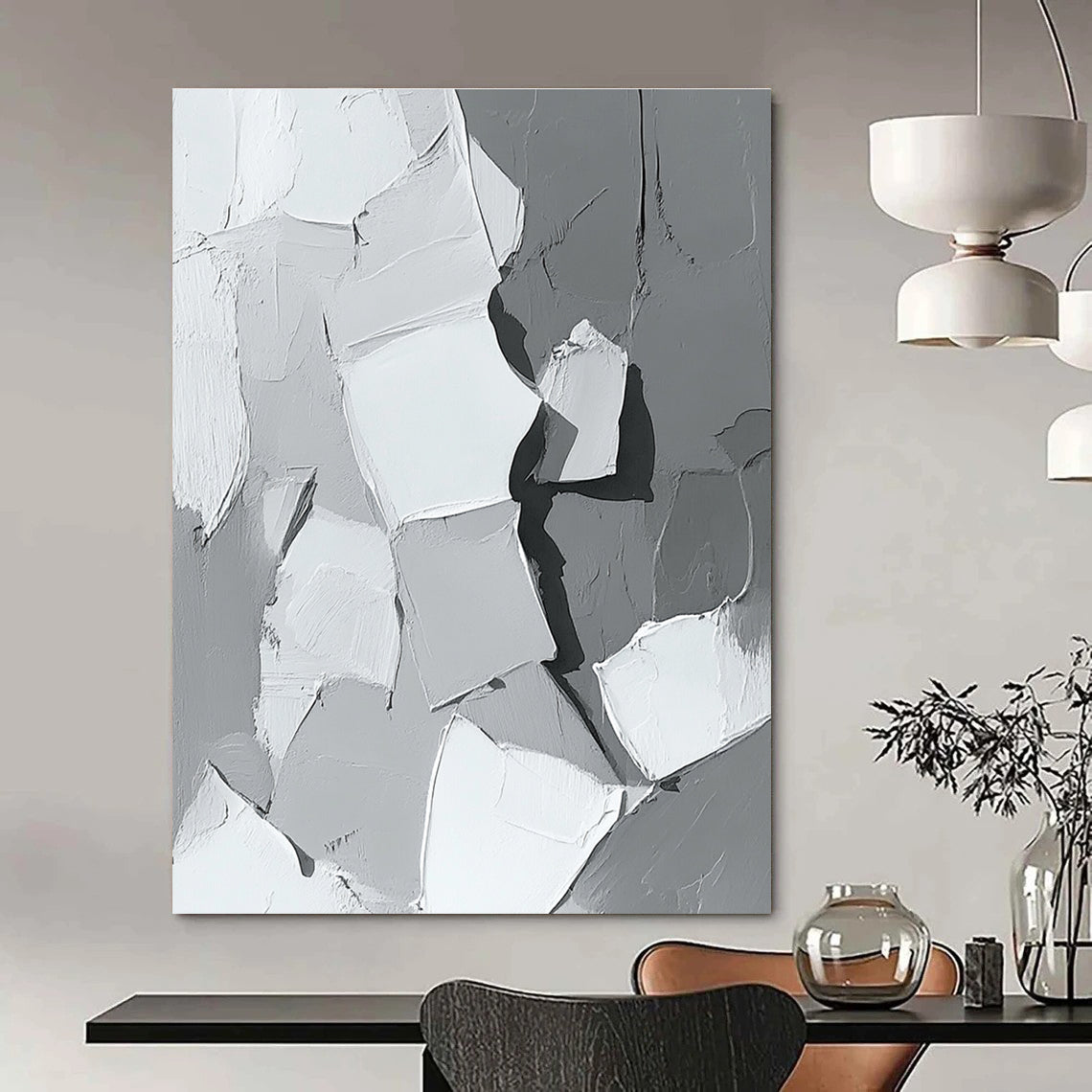 Large abstract painting in gray and white showcasing body parts in armor with bold brush strokes and thick paint application in a striking monochrome palette.STSC479